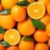 fresh orange fruits with leaves as background, top view Baladi Oranges